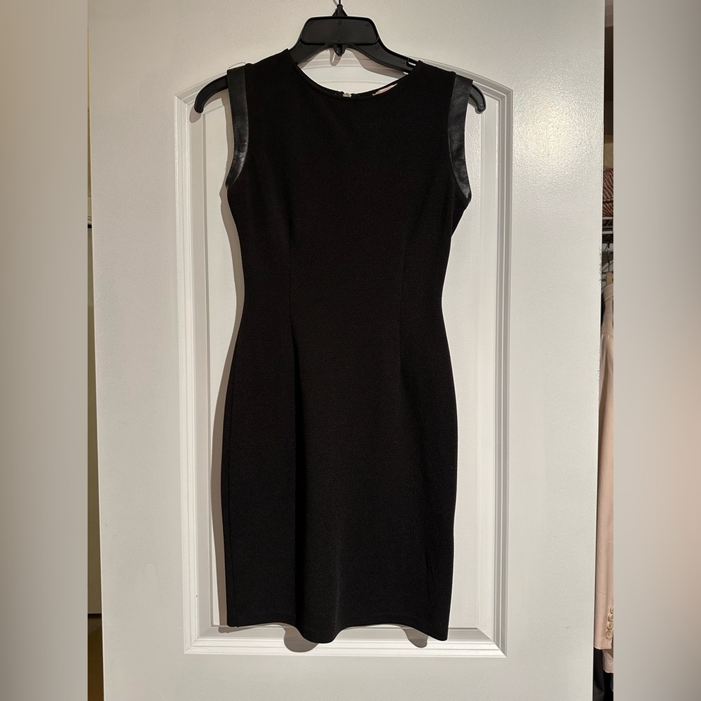 Black body con fitted mini dress with faux leather capped sleeve